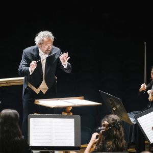 a conductor conducting an orchestra