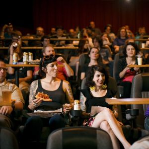 movie goers enjoy pizza and beer