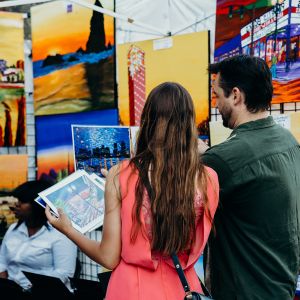 two people look at art on display