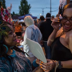 a woman selling artistic hair accessories to a customer at last thursday art walk