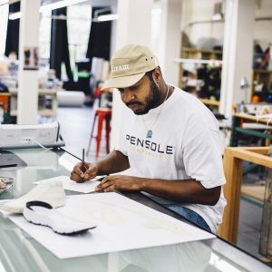 a designer looks at a sneaker