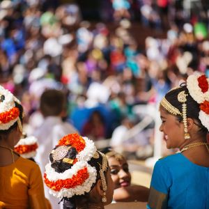 Indian people wearing traditional headpieces gathered at a festival.