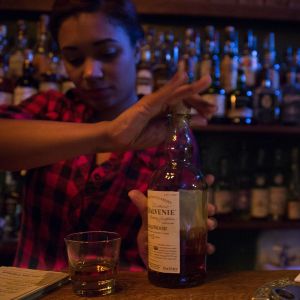 a bartender prepares a drink