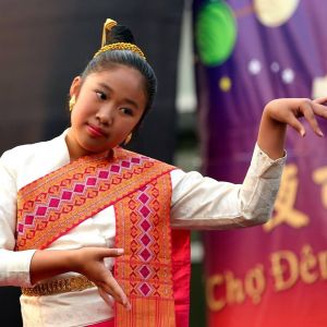 a dancer wearing a colorful sash