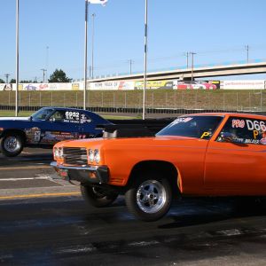 Two cars drag race at Portland International Raceway.