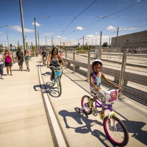 People riding bikes and walking across the Tilikum Crossing Bridge