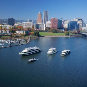 four cruise ships of varying sizes on the Willamette River