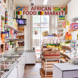 a sunlit and orderly store is filled with food items