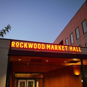 The entry door and sign to Rockwood Market Hall at dusk