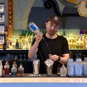 a bartender mixes a cocktail