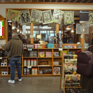 people at books shelves in a books store