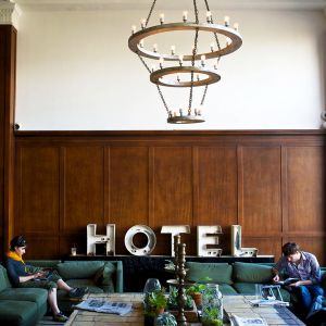 two people seated on a couch in a hotel lobby