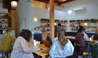 people working and enjoying coffee in a bright airy café