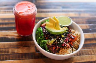 a healthy bowl of gluten-free food with a glass of juice