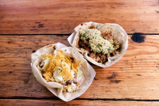 two tacos on a wooden table