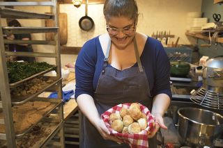 Chef Maya Lovelace carrying a basket full of biscuits