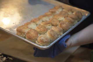 a sheet-pan of biscuits being pulled from an oven