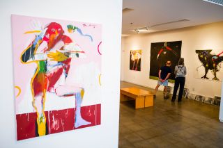 two people looking at artwork in a gallery