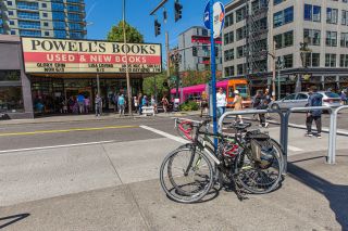 bikes locked to a bike rack across the street from the entrance of Powell's Books