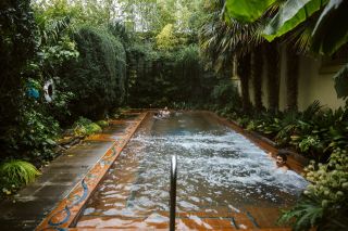 a man enjoying a warm water, outdoor pool