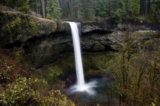 silver falls cascading down to a small lake below with fall colors on surround trees