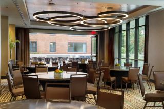 tables set up in a meeting space at the Porter Hotel