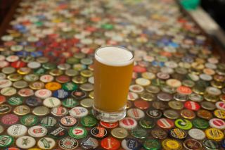 Pint of beer on bottlecap table