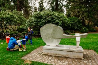 a family stands next to a public art statue