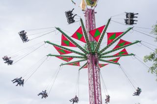 people enjoy an amusement park ride at festivals in Waterfront Park