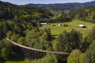 aerial view of the countryside and coastal range with an old rail bridge turned bike and walking path