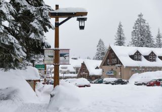 A blanket of snow covers the streets, cars and buildings of Government Camp.