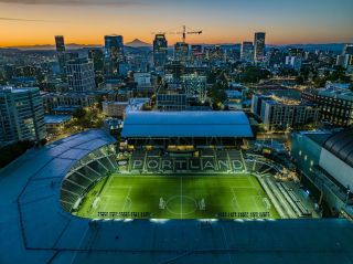 a large soccer stadium lit up at night time