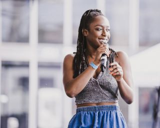 Woman singing R&B into a microphone