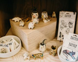 a display of small ceramic animals and hand made cards