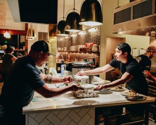 chef Lamagna preparing dishes for tasting event