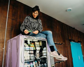 person sitting on top of a vending machine
