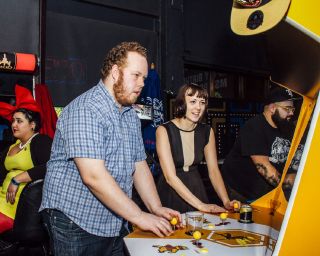 two people playing arcade games at Ground Kontrol