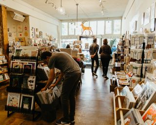 shoppers browse a shop packed with locally-made goods.