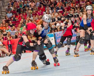 Two opposing roller derby players collide