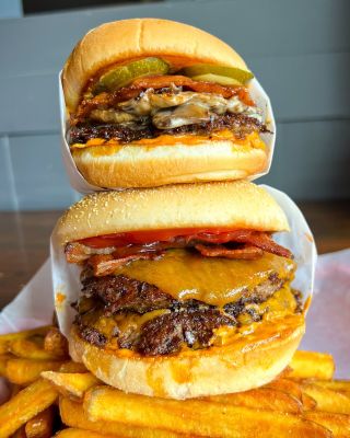 two hamburgers stacked on top of fries