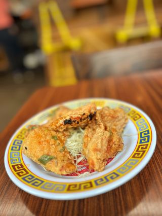 a plate of sweet and sour fried chicken on a table