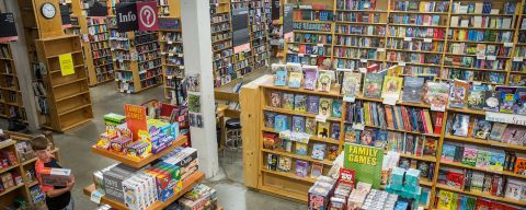 a large room filled with bookshelves and display tables covered with books