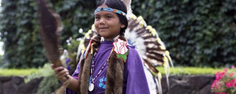 a girl dressed in Native American dance regalia