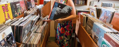 a woman browsing through vinyl albums at Mississippi Records