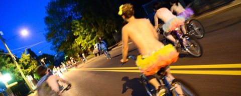 people on bikes at night wearing very little clothing