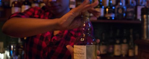 a bartender prepares a drink