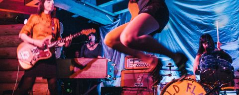 a band performs on stage at a music venue