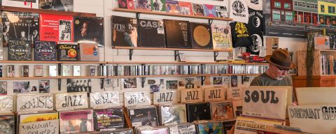 A man browses bins of records in a vintage record store