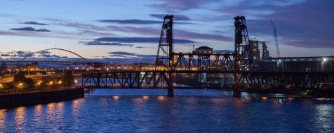 Portland\'s steel bridge spanning the Willamette River at sunset