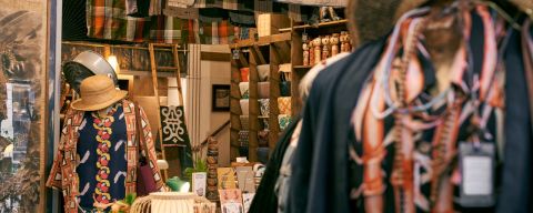 A shop display including apparel, fabric, and homewares.